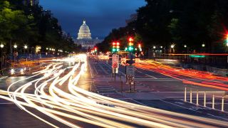 traffic on a road at night in front of the Capitol in DC